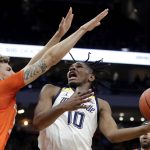 
              Marquette's Justin Lewis (10) shoots against Illinois' Coleman Hawkins during the first half of an NCAA college basketball game Monday, Nov. 15, 2021, in Milwaukee. (AP Photo/Aaron Gash)
            