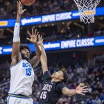 
              UCLA center Myles Johnson (15) shoots over Gonzaga guard Rasir Bolton (45) during the first half of an NCAA college basketball game Tuesday, Nov. 23, 2021, in Las Vegas. (AP Photo/L.E. Baskow)
            