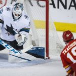 
              San Jose Sharks goalie Adin Hill makes a save on Calgary Flames' Matthew Tkachuk during the second period of an NHL hockey game, Tuesday, Nov. 9, 2021 in Calgary, Alberta. (Jeff McIntosh/The Canadian Press via AP)
            