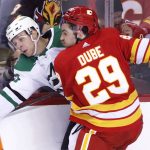 
              Dallas Stars' Esa Lindell, left, takes a hit from Calgary Flames' Dillon Dube during the second period of an NHL hockey game Thursday, Nov. 4, 2021, in Calgary, Alberta. (Larry MacDougal/The Canadian Press via AP)
            