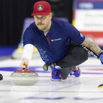 
              Team Shuster's Matt Hamilton throws the rock while competing against Team Dropkin during the third night of finals at the U.S. Olympic Curling Team Trials at Baxter Arena in Omaha, Neb., Sunday, Nov. 21, 2021. (AP Photo/Rebecca S. Gratz)
            