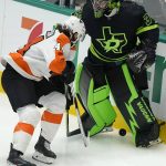 
              Dallas Stars goaltender Anton Khudobin (35) and Philadelphia Flyers center Nate Thompson (44) play the puck off the boards during the first period of an NHL hockey game in Dallas, Saturday, Nov. 13, 2021. (AP Photo/LM Otero)
            