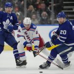 
              Toronto Maple Leafs forwards Nick Ritchie (20) and Mitchell Marner (16) battle for the puck against New York Rangers forward Kaapo Kakko (24) during second-period NHL hockey action in Toronto, Thursday, Nov. 18, 2021. (Nathan Denette/The Canadian Press via AP)
            
