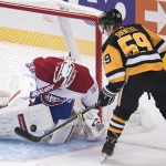 
              Montreal Canadiens goaltender Jake Allen (34) stops a shot by Pittsburgh Penguins' Jake Guentzel (59) during the first period of an NHL hockey game in Pittsburgh, Saturday, Nov. 27, 2021. (AP Photo/Gene J. Puskar)
            