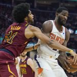 
              Cleveland Cavaliers' Jarrett Allen, left, tries to knock the ball loose from Phoenix Suns' Deandre Ayton (22) during the first half of an NBA basketball game Wednesday, Nov. 24, 2021, in Cleveland. (AP Photo/Tony Dejak)
            