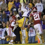 
              LSU wide receiver Jack Bech (80) makes a touchdown catch against Arkansas defensive back Malik Chavis (4) during the first half of an NCAA college football game in Baton Rouge, La., Saturday, Nov. 13, 2021. (AP Photo/Matthew Hinton)
            