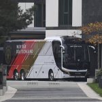 
              The team bus of Germany's national soccer team is parked in front of the team hotel in Wolfsburg, Germany, prior the World Cup qualifying match against Liechtenstein, Tuesday, Nov. 9, 2021. There is said to be a positive Corona case in the circle of the national soccer team. National coach Hansi Flick cancelled the planned training in the morning at the stadium in Wolfsburg. Five players have to be quarantined in Wolfsburg. (Swen Pfoertner/dpa via AP)
            