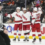 
              Carolina Hurricanes center Martin Necas (88), defenseman Ethan Bear (25) and center Vincent Trocheck (16) celebrate after Bear scored a goal during the first period of an NHL hockey game against the Anaheim Ducks in Anaheim, Calif., Thursday, Nov. 18, 2021. (AP Photo/Ashley Landis)
            