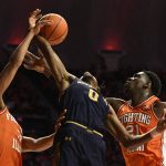 
              Notre Dame's Blake Wesley (0) Illinois' Kofi Cockburn (21) and Illinois' Jacob Grandison vie for a rebound during the first half of an NCAA college basketball game Monday, Nov. 29, 2021, in Champaign, Ill. (AP Photo/Michael Allio)
            
