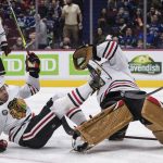 
              Chicago Blackhawks' Seth Jones, left, falls over goalie Marc-Andre Fleury during the second period of an NHL hockey game against the Vancouver Canucks, in Vancouver, British Columbia, Sunday, Nov. 21, 2021. (Darryl Dyck/The Canadian Press via AP)
            