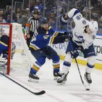 
              Tampa Bay Lightning's Ondrej Palat (18) handles the puck while under pressure from St. Louis Blues' Scott Perunovich (48) during the third period of an NHL hockey game Tuesday, Nov. 30, 2021, in St. Louis. (AP Photo/Scott Kane)
            