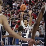 
              Gonzaga guard Rasir Bolton, back, shoots over Dixie State guard Cameron Gooden during the first half of an NCAA college basketball game, Tuesday, Nov. 9, 2021, in Spokane, Wash. (AP Photo/Young Kwak)
            