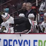 
              Chicago Blackhawks' Seth Jones is checked into the Chicago bench by Vancouver Canucks' Tyler Motte, not seen, during the second period of an NHL hockey game against the Vancouver Canucks in Vancouver, British Columbia, Sunday, Nov. 21, 2021. (Darryl Dyck/The Canadian Press via AP)
            