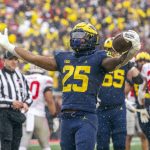 
              Michigan running back Hassan Haskins (25) celebrates a touchdown in the fourth quarter of an NCAA college football game against Ohio State in Ann Arbor, Mich., Saturday, Nov. 27, 2021. Michigan won 42-27. (AP Photo/Tony Ding)
            