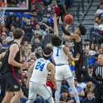 
              Gonzaga guard Julian Strawther (0) goes up for a shot over UCLA guard Jules Bernard (1) during the first half of an NCAA college basketball game Tuesday, Nov. 23, 2021, in Las Vegas. (AP Photo/L.E. Baskow)
            