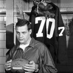 
              FILE - Washington Redskins' Sam Huff poses in front of his jersey in the locker room in Washington in December 1967. Huff announced his retirement at season's end. Huff later returned to play with the Redskins. Huff, the hard-hitting Hall of Fame linebacker who helped the Giants reach six NFL title games from the mid-1950s to the early 1960s and later became a popular player and announcer in Washington, died Saturday, Nov. 13, 2021. He was 87. (AP Photo, File)
            