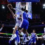 
              Orlando Magic's Franz Wagner, left, cannot get a shot past Philadelphia 76ers' Andre Drummond during the first half of an NBA basketball game, Monday, Nov. 29, 2021, in Philadelphia. (AP Photo/Matt Slocum)
            