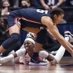 
              Connecticut's Azzi Fudd, top, reaches for the ball lost by Arkansas' Marquesha Davis, bottom, in the second half of an NCAA college basketball game, Sunday, Nov. 14, 2021, in Hartford, Conn. (AP Photo/Jessica Hill)
            