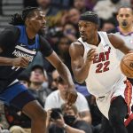 
              Miami Heat forward Jimmy Butler (22) drives past Minnesota Timberwolves center Naz Reid during the first half of an NBA basketball game Wednesday, Nov. 24, 2021, in Minneapolis. (AP Photo/Craig Lassig)
            