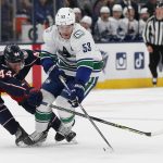 
              Columbus Blue Jackets' Vladislav Gavrikov, left, knocks the puck away from Vancouver Canucks' Bo Horvat during the first period of an NHL hockey game Friday, Nov. 26, 2021, in Columbus, Ohio. (AP Photo/Jay LaPrete)
            