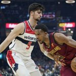 
              Cleveland Cavaliers' Evan Mobley (4) drives against Washington Wizards' Deni Avdija (9) in the first half of an NBA basketball game, Wednesday, Nov. 10, 2021, in Cleveland. (AP Photo/Tony Dejak)
            