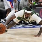 
              Milwaukee Bucks center Bobby Portis dives for the loose ball during the first half of an NBA basketball game against the Detroit Pistons, Tuesday, Nov. 2, 2021, in Detroit. (AP Photo/Carlos Osorio)
            