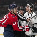 
              An official pulls apart Washington Capitals right wing Garnet Hathaway (21) and Los Angeles Kings right wing Adrian Kempe (9) during the first period of an NHL hockey game Wednesday, Nov. 17, 2021, in Los Angeles. (AP Photo/Ashley Landis)
            