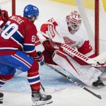 
              Detroit Red Wings goaltender Alex Nedeljkovic (39) stops Montreal Canadiens' Alex Belzile (60) during the second period of an NHL hockey game Tuesday, Nov. 2, 2021, in Montreal. (Ryan Remiorz/The Canadian Press via AP)
            