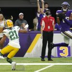 
              Minnesota Vikings wide receiver Justin Jefferson, right, catches a 23-yard touchdown pass ahead of Green Bay Packers cornerback Eric Stokes (21) during the second half of an NFL football game, Sunday, Nov. 21, 2021, in Minneapolis. The Vikings won 34-31. (AP Photo/Jim Mone)
            