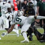 
              Michigan State running back Kenneth Walker III (9) is tackled by Purdue cornerback Jamari Brown (7) during the second half of an NCAA college football game in West Lafayette, Ind., Saturday, Nov. 6, 2021. (AP Photo/Michael Conroy)
            