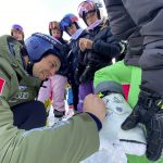 
              Matteo Marsaglia, of Italy, signs autographs for young fans after the cancelation of the FIS World Cup downhill ski race in Lake Louise, Alberta on Friday Nov. 26, 2021. The race was cancelled due to too much snow on the course. (Frank Gunn/The Canadian Press via AP)
            