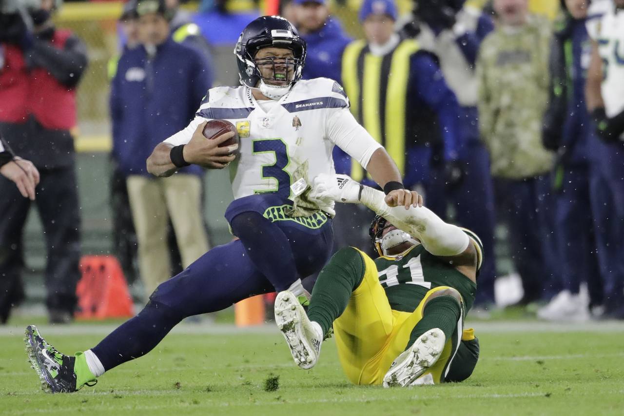Seattle Seahawks' Russell Wilson is sacked by Green Bay Packers' Preston Smith during the second ha...