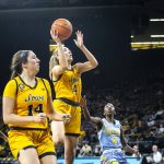 
              Iowa guard Kylie Feuerbach, center, shoots the ball as Southern's Chloe Fleming (4) watches defends during an NCAA college basketball game, Wednesday, Nov. 17, 2021, at Carver-Hawkeye Arena in Iowa City, Iowa. (Joseph Cress/Iowa City Press-Citizen via AP)
            