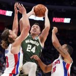 
              Milwaukee Bucks guard Pat Connaughton (24) is defended by Detroit Pistons forward Kelly Olynyk, left and guard Cory Joseph (18) during the first half of an NBA basketball game, Tuesday, Nov. 2, 2021, in Detroit. (AP Photo/Carlos Osorio)
            