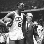 
              FILE - Bill Russell, left, star of the Boston Celtics is congratulated by coach Arnold "Red" Auerbach after scoring his 10,000th point in the NBA game against the Baltimore Bullets in Boston on Dec. 12, 1964. (AP Photo/Bill Chaplis, File)
            