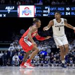 
              Ohio State's Eugene Brown III, left, defends as Xavier's Paul Scruggs (1) controls the ball during the second half of an NCAA college basketball game, Thursday, Nov. 18, 2021, in Cincinnati. (AP Photo/Aaron Doster)
            