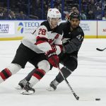 
              New Jersey Devils defenseman Damon Severson (28) movesthe puck around Tampa Bay Lightning center Pierre-Edouard Bellemare (41) during the second period of an NHL hockey game Saturday, Nov. 20, 2021, in Tampa, Fla. (AP Photo/Chris O'Meara)
            
