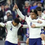 
              United States' Weston McKennie celebrates his goal with Tyler Adams, left, and Christian Pulisic during the second half of a FIFA World Cup qualifying soccer match against Mexico, Friday, Nov. 12, 2021, in Cincinnati. The U.S. won 2-0. (AP Photo/Julio Cortez)
            