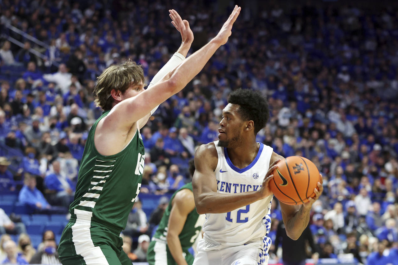 Kentucky's Keion Brooks Jr. (12) is pressured Ohio's Ben Vander Plas (5) during the first half of a...