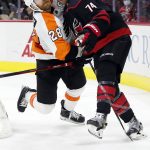 
              Carolina Hurricanes' Jaccob Slavin (74) collides with Philadelphia Flyers' Claude Giroux (28) during the third period of an NHL hockey game in Raleigh, N.C., Friday, Nov. 12, 2021. (AP Photo/Karl B DeBlaker)
            