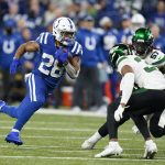 
              Indianapolis Colts' Jonathan Taylor (28) runs against New York Jets' Bryce Hall (37) during the first half of an NFL football game, Thursday, Nov. 4, 2021, in Indianapolis. (AP Photo/Michael Conroy)
            