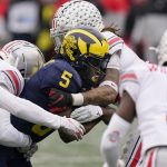 
              Michigan wide receiver Mike Sainristil (5) is stopped by the Ohio State defense during the second half of an NCAA college football game, Saturday, Nov. 27, 2021, in Ann Arbor, Mich. (AP Photo/Carlos Osorio)
            