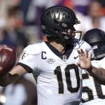 
              Wake Forest quarterback Sam Hartman (10) sets to pass during the first half of an NCAA college football game against Clemson, Saturday, Nov. 20, 2021, in Clemson, S.C. (AP Photo/Brynn Anderson)
            