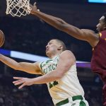 
              Boston Celtics' Payton Pritchard (11) drives to the basket against Cleveland Cavaliers' Evan Mobley (4) in the first half of an NBA basketball game, Monday, Nov. 15, 2021, in Cleveland. (AP Photo/Tony Dejak)
            