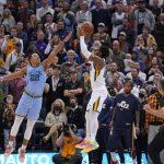
              Utah Jazz guard Donovan Mitchell (45) misses the last shot as Memphis Grizzlies guard Desmond Bane (22) defends during the second half of an NBA basketball game Monday, Nov. 22, 2021, in Salt Lake City. (AP Photo/Rick Bowmer)
            