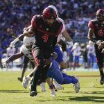 
              San Diego State quarterback Jordon Brookshire (4) celebrates after scoring a touchdown during the second half of an NCAA college football game against the Boise State in Carson, Calif., Friday, Nov. 26, 2021. (AP Photo/Ashley Landis)
            