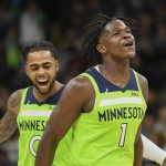 
              Minnesota Timberwolves guard Anthony Edwards (1) and guard D'Angelo Russell react after Edwards made a three point shot during the first half of an NBA basketball game Saturday, Nov. 20, 2021, in Minneapolis. (AP Photo/Craig Lassig)
            