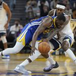 
              Golden State Warriors forward Draymond Green, foreground, loses the ball while defended by Minnesota Timberwolves forward Jarred Vanderbilt during the first half of an NBA basketball game in San Francisco, Wednesday, Nov. 10, 2021. (AP Photo/Jeff Chiu)
            