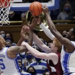 
              Duke forward Paolo Banchero (5) and center Mark Williams, right, battle Lafayette forward Leo O'Boyle, center, for a rebound during the first half of an NCAA college basketball game Friday, Nov. 19, 2021, in Durham, N.C. (AP Photo/Chris Seward)
            