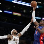 
              Detroit Pistons guard Hamidou Diallo, right, shoots over Los Angeles Lakers forward Carmelo Anthony during the second half of an NBA basketball game Sunday, Nov. 28, 2021, in Los Angeles. (AP Photo/Alex Gallardo)
            
